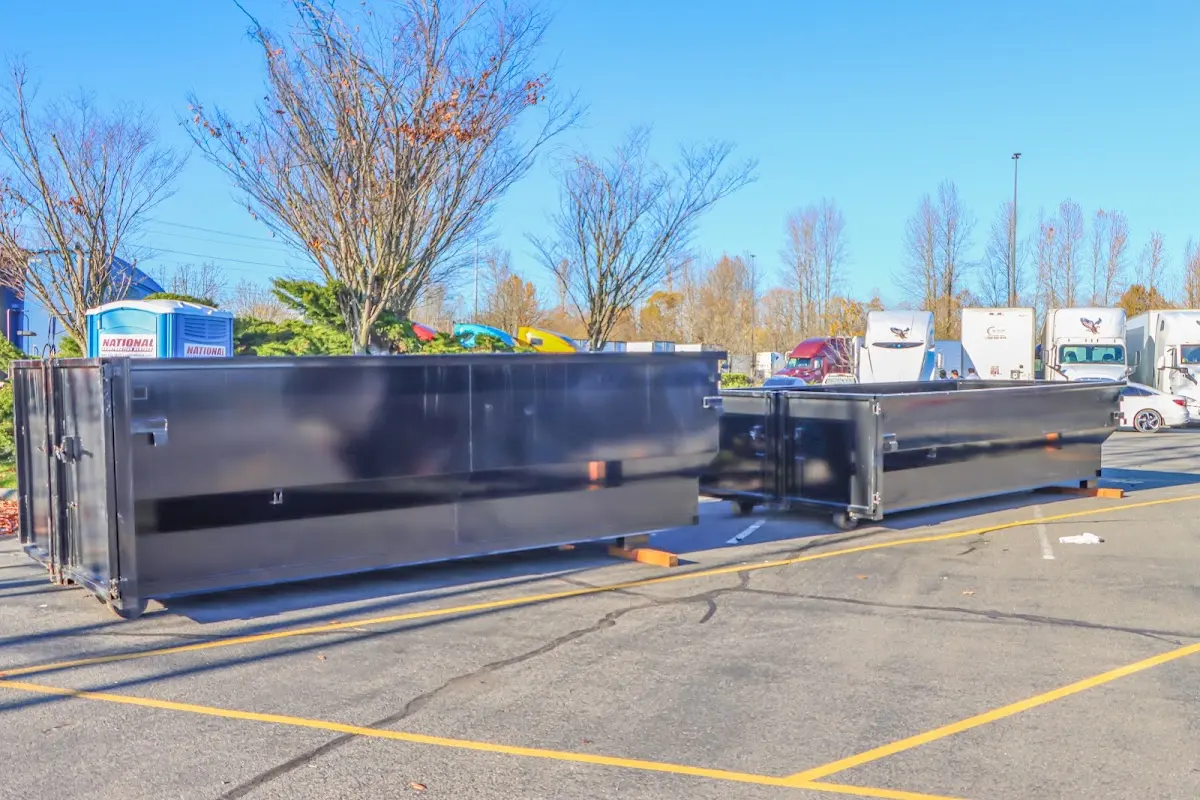 Professional dumpster rental service with roll-off container on residential driveway in Elfers